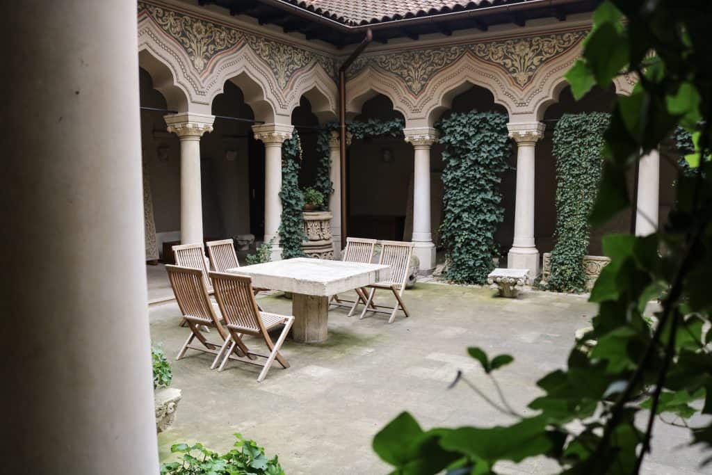 The beautiful courtyard outside of the Stavropoleos Church located in Old Town, Bucharest. Plenty of green ivy throughout the courtyard.