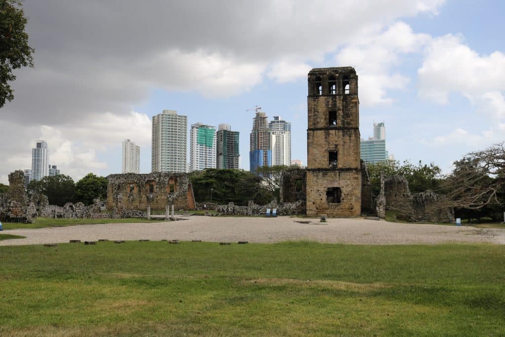 Contrasting view of old ruins of Panama Viejo with modern high rises behind.