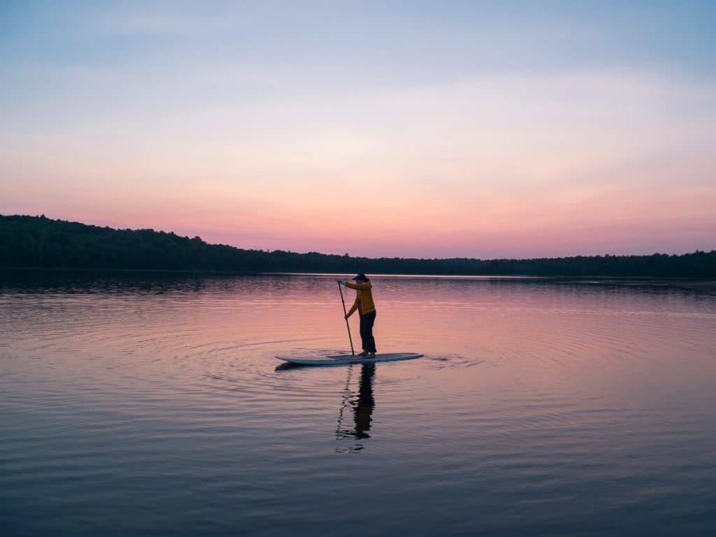 a person paddle boarding to stay fit