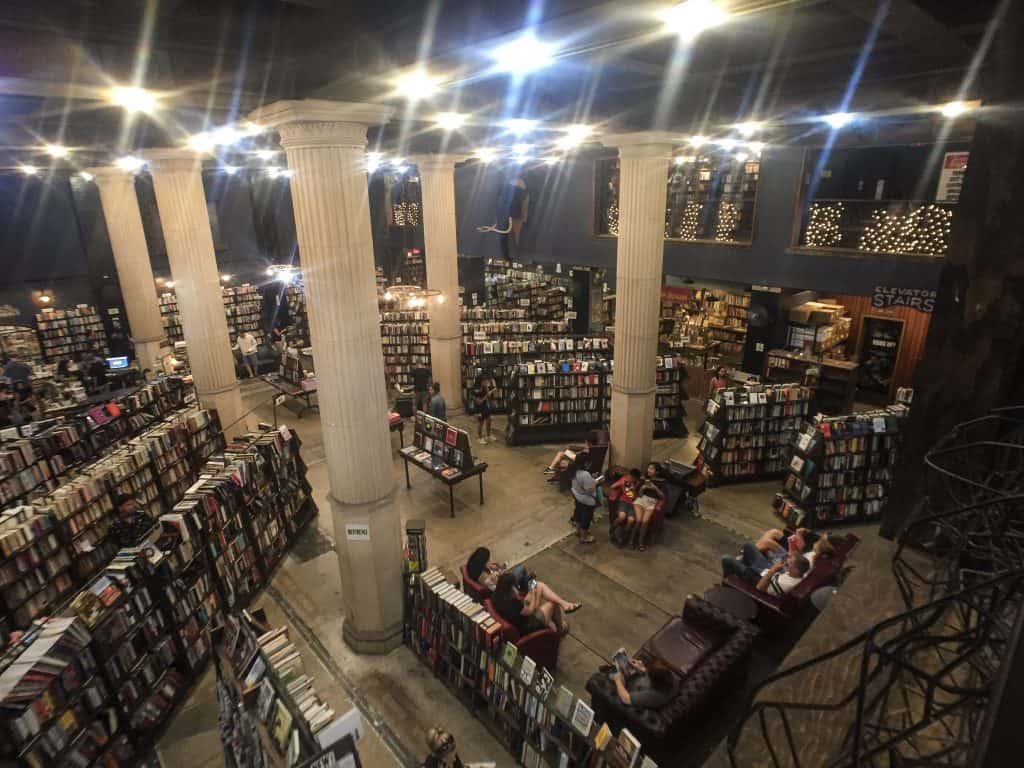 Inside the Last Bookstore with tall columns and rows of books seen from the 2nd story balcony in DTLA.