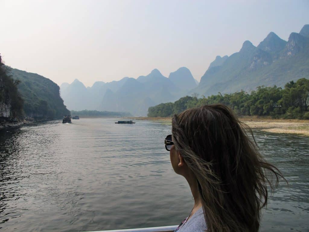 Adventure awaits cruising on the Li River in Gulin, China admiring the pinnacle formations.