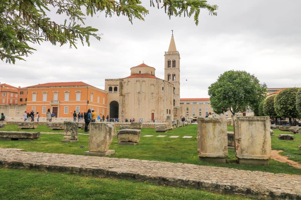 Ruins of the Roman Forum and the church and bell tower in the distance in Zadar old town.