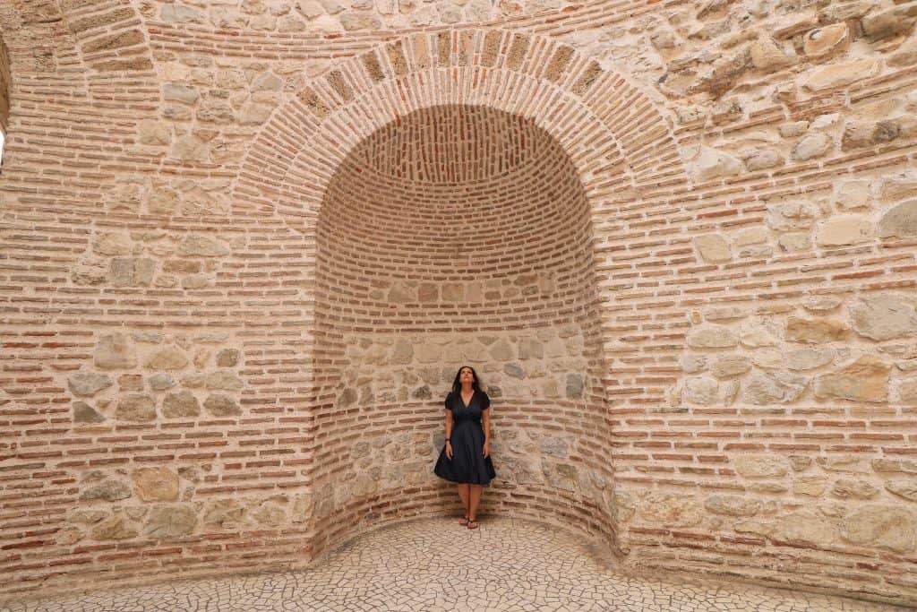 Me standing and looking up, taking in the beautiful architecture of the Vestibule in Split with its bricks and stonework in shades of red and white.
