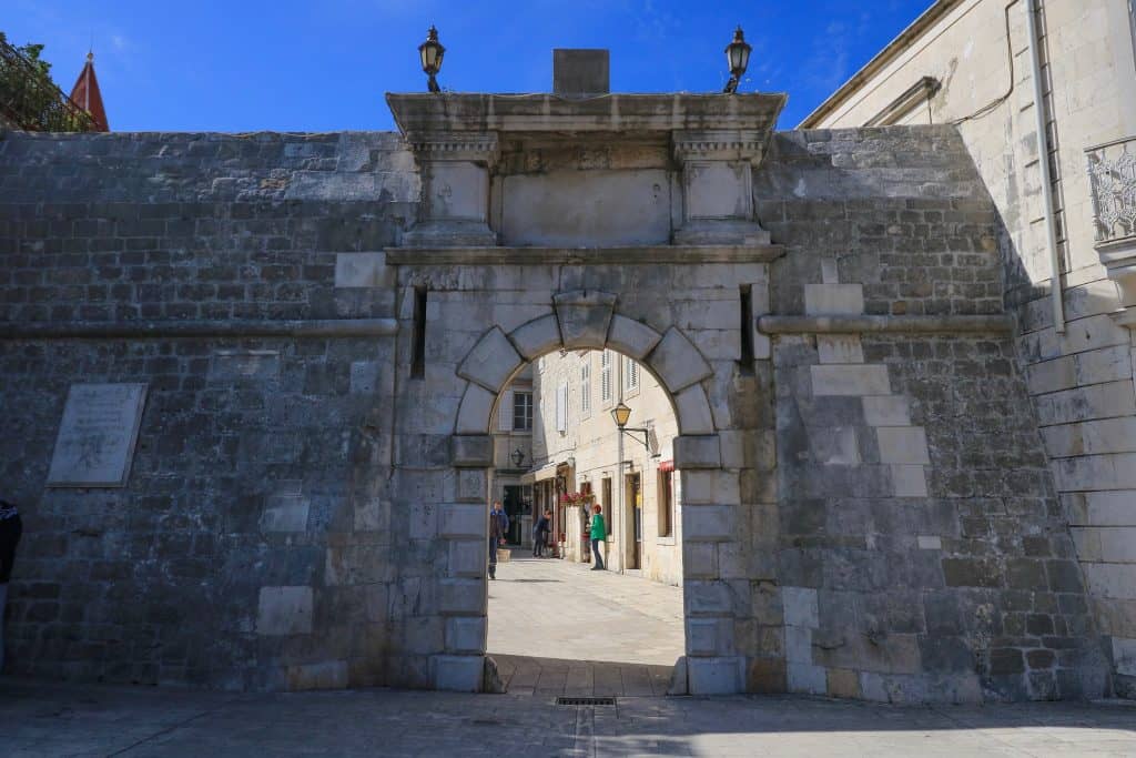 The North Gate entrance with arched stonework into old town Trogir in Croatia.