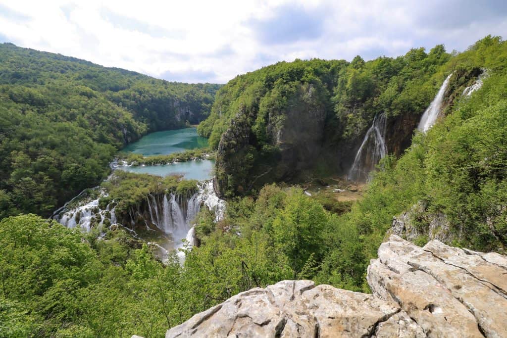 The beauty of the Plitvice waterfalls is magical with several huge waterfalls, lakes and rocky cliff in view.