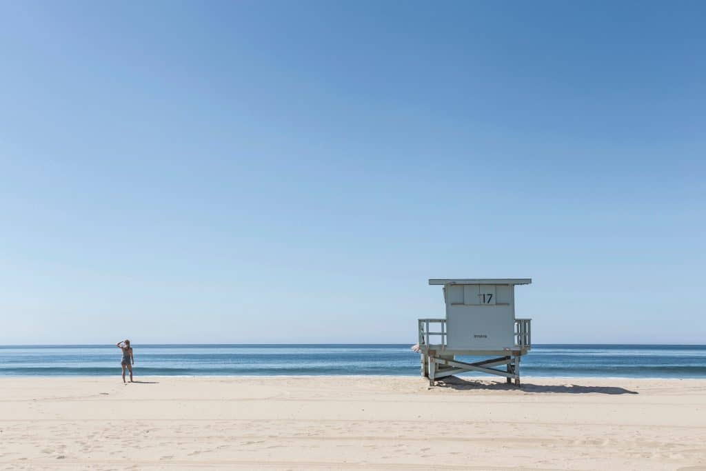 A sunny beach and lifeguard tower