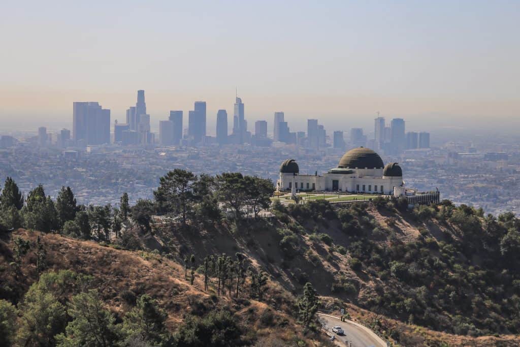 A closer view of the Griffith Observatory with downtown LA behind it in the distance.