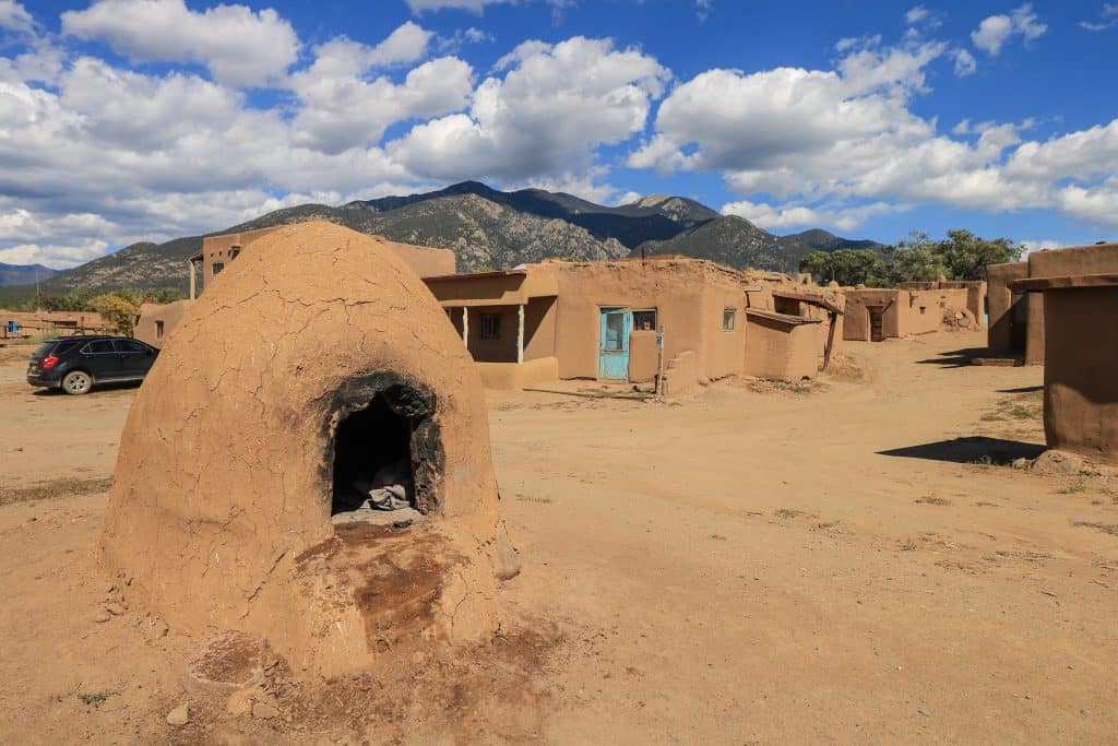 A horno which is a rounded stand alone outdoor oven used to make breads and baked goods outside of the homes at Taos Pueblo in Taos, New Mexico.