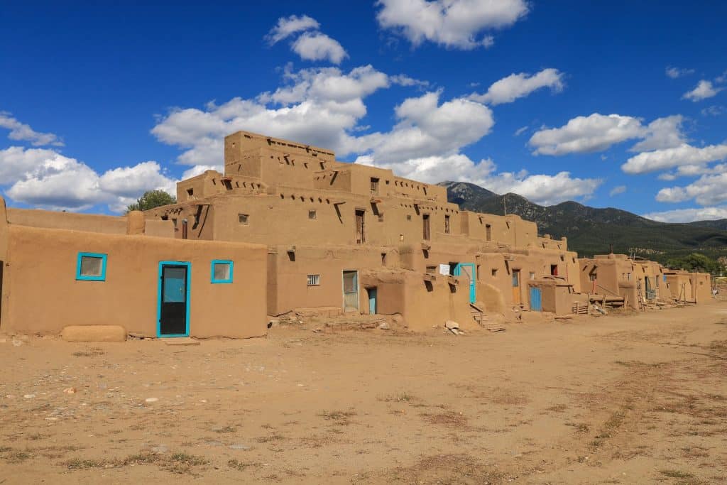The largest complex of adobe houses at Taos Pueblo with its tan adobe exterior and bright turquoise doors and windows is by far my favorite day trip from Santa Fe.