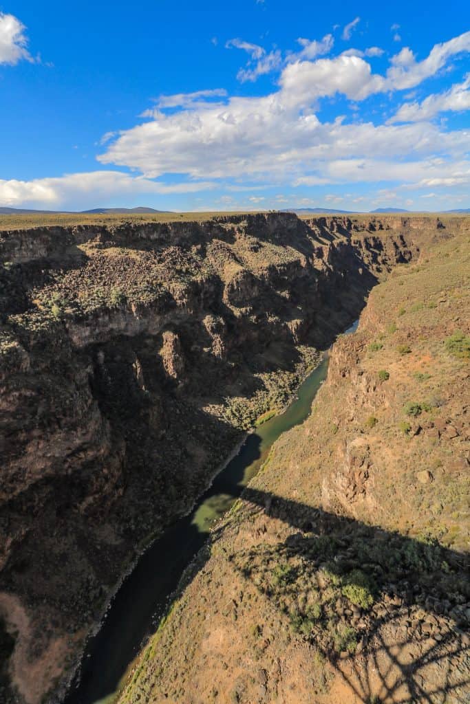 Looking down at the Rio Grande River in New Mexico carved out into a very deep canyon which took years to erode.