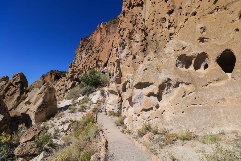 The trail is pretty flat other than a small section meandering between tall walls of rock at Bandelier National Monument in New Mexico.