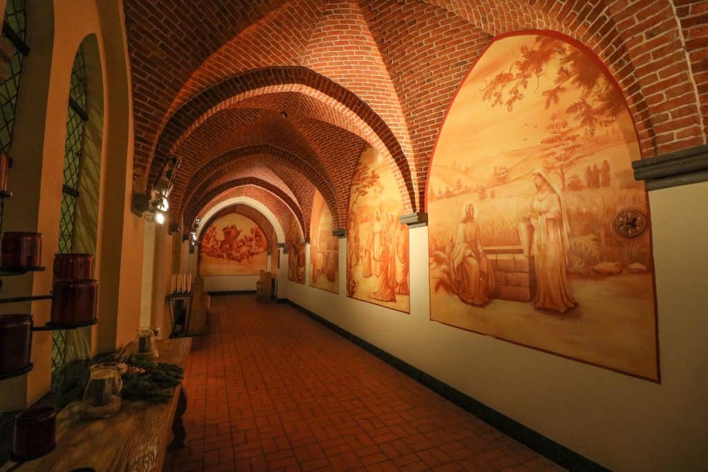 Looking down a hallway with arched brick ceilings and old paintings on the walls are gorgeous from the old convent, now the La Merveilleuse hotel.