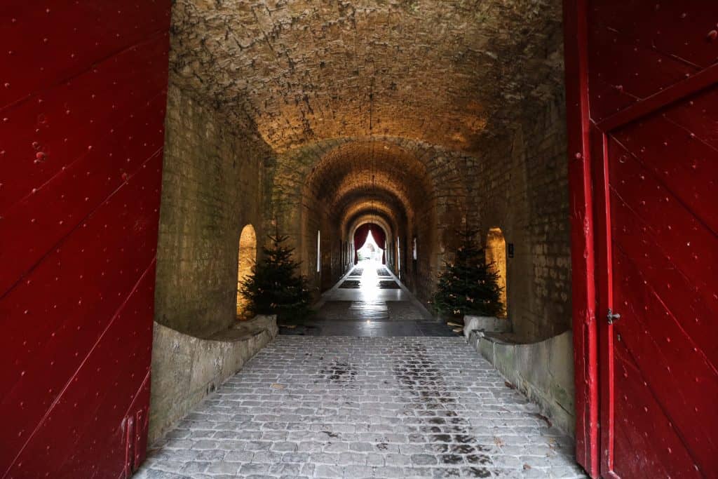 The stone hallway with arched ceiling leading to the Citadel's courtyard high up on a sheer cliff in Dinant, Belgium.