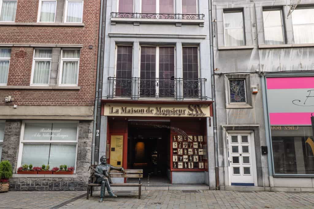 The actual home of Adolphe Sax who invented the saxophone and now serves as the museum with a statue of him in front in Dinant.