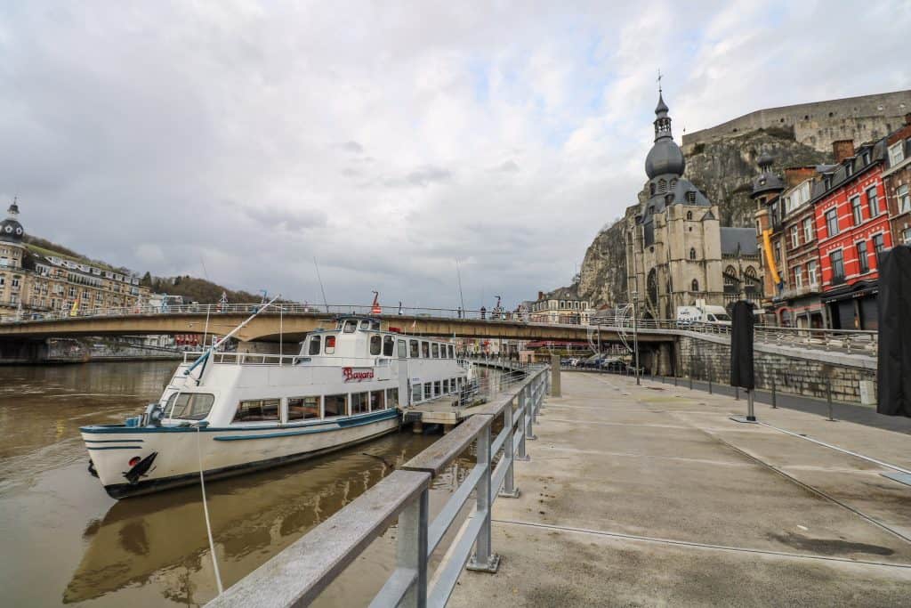 A boat docked against the promenade where boat rides take off near the Charles de Gaulle bridge.