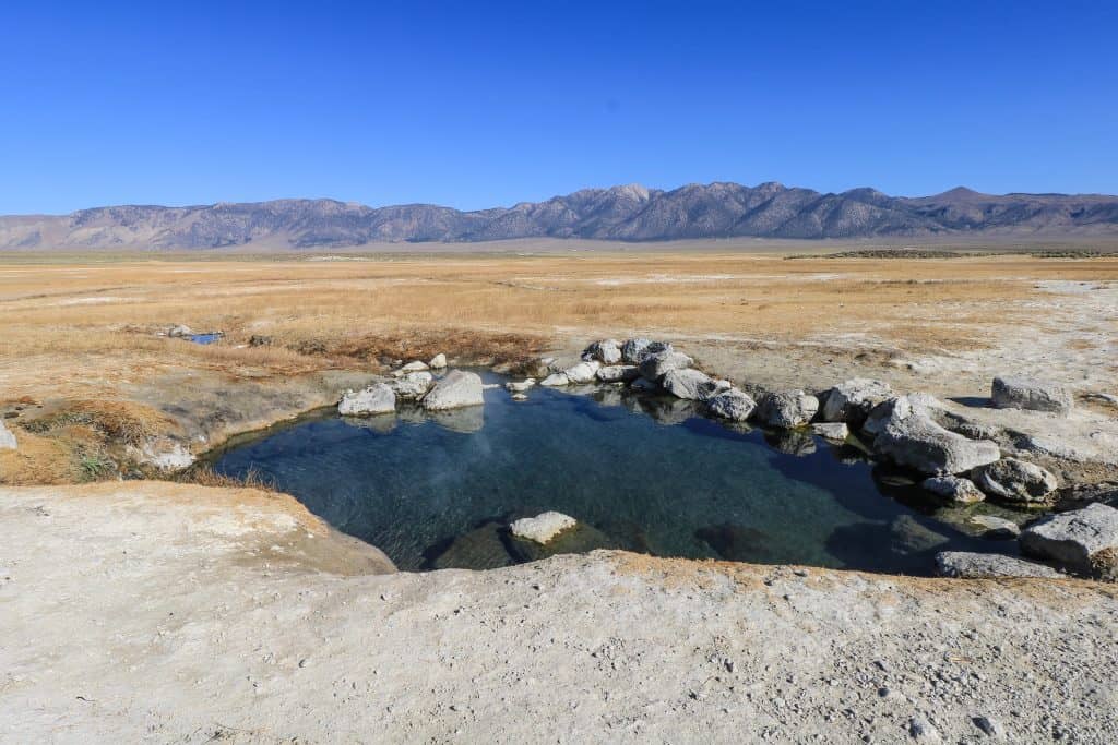 It doesn't get any better than this soaking in a beautiful, natural pool and one of the best Mammoth Lakes hot springs in the area with a flat terrain before a tall mountain range in the distance.