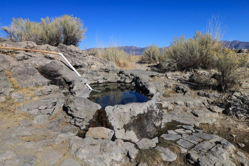 This small natural hot springs pool really does look like a small hot tub that can fit between 2-4 people at most.