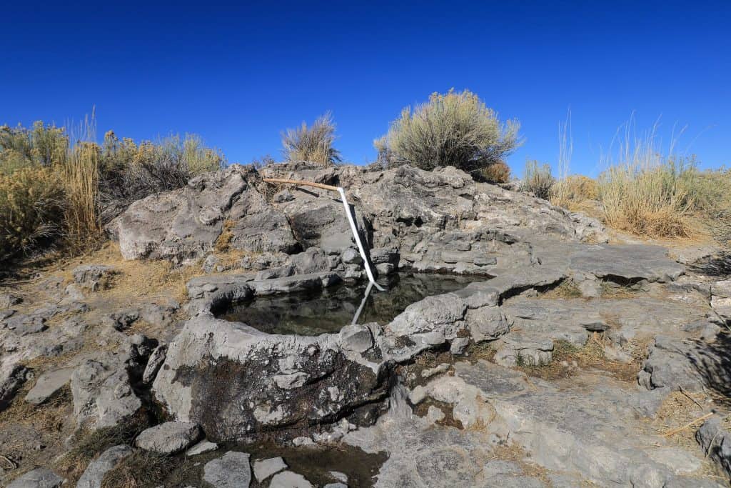 Rock Tub is a bit small and perfect for two, maybe 4 and one of the top hot springs in Mammoth Lakes California with small bushes surrounding it.