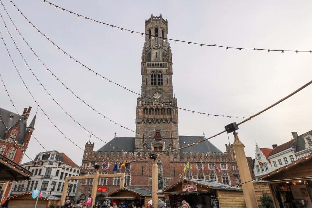 Looking up at the Belfort from the festive Christmas Market in Bruges, Belgium.