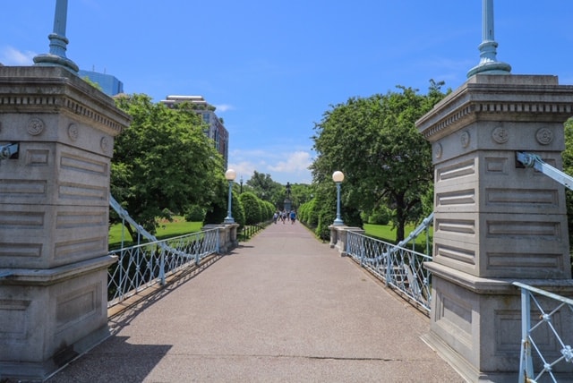Walking over the Lagoon Bridge in Public Garden in the heart of Boston, MA.