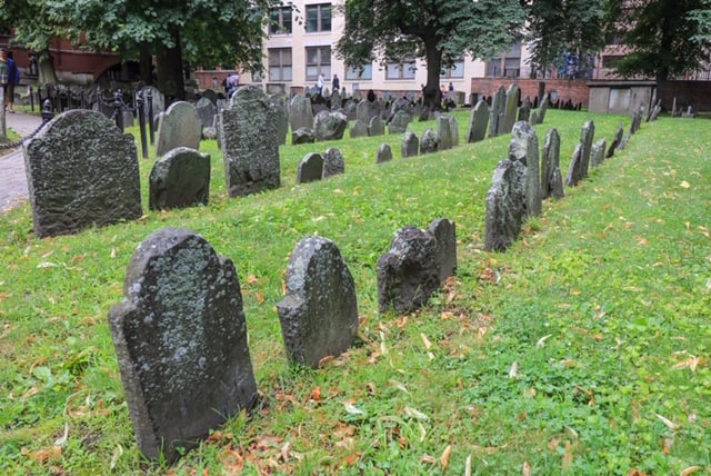 Rows of old headstone markers that are worn over the years in the Granary Burying Ground which dates back to 1660.