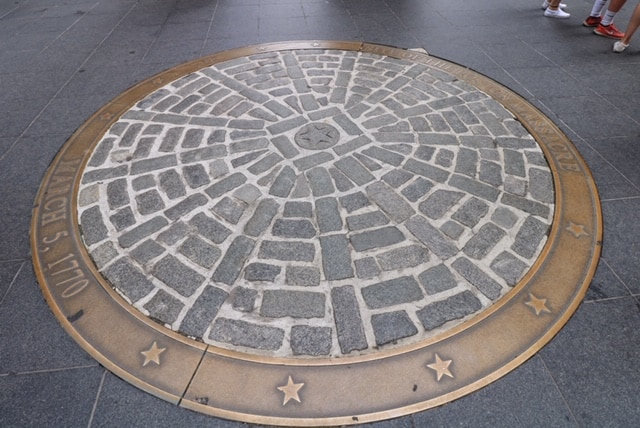 A metal plate on a section of the Boston Freedom Trail marking the site of the Boston Massacre.