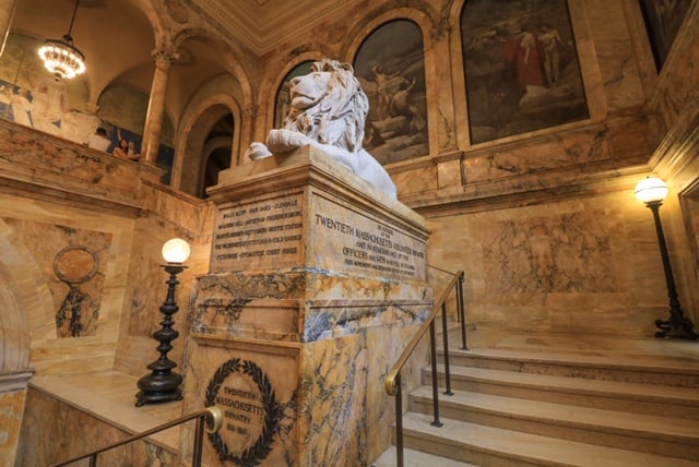 A lion statue looks on guard as it greets you to the library as you go up the main staircase.