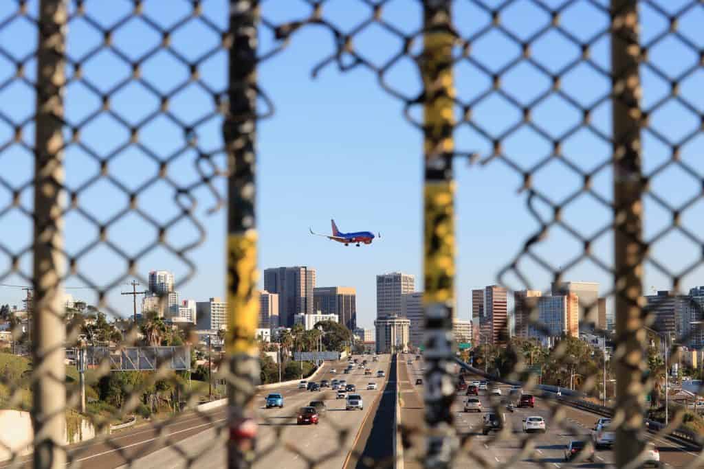 A plane coming in over downtown San Diego and about to land