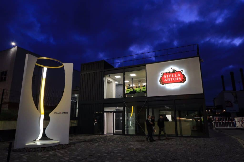 The front of the Stella Artois building lit up at night during blue hour