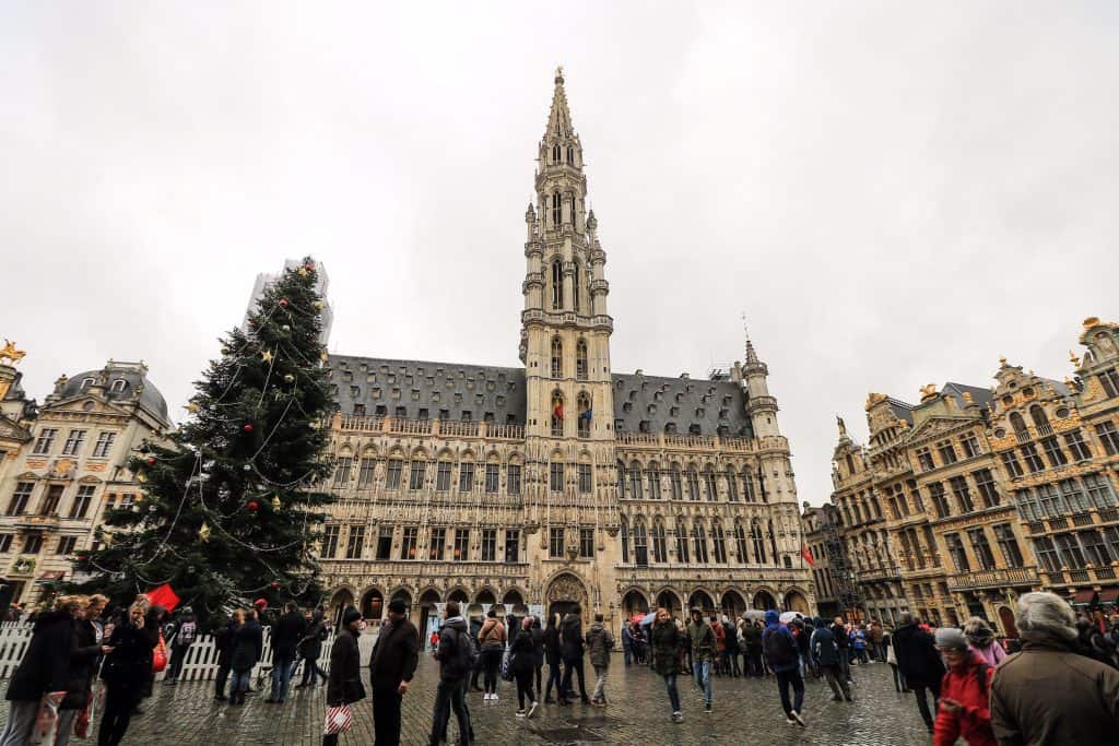 A huge Christmas tree and beautiful architecture of surrounding buildings of the Grand Place