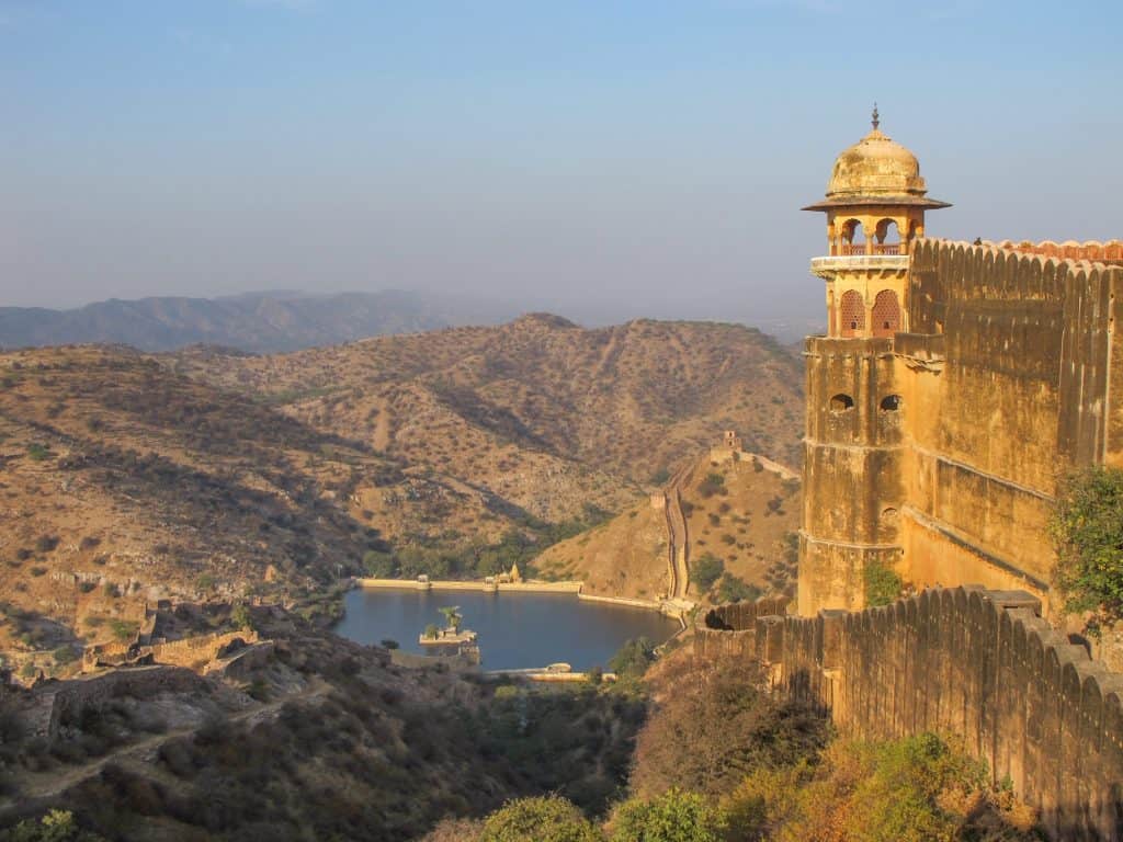 View of tower and walls of Jaigarh Fort with a small lake in the background