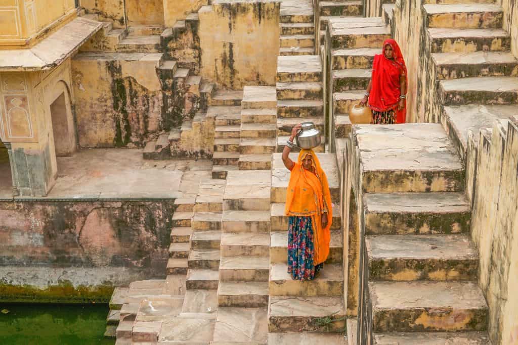 Two women collecting water at Panna Meena Ka Kund In Jaipur