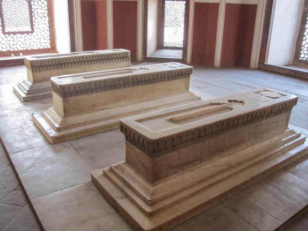 Three white marble tombs inside of the Humayun mausoleum 
