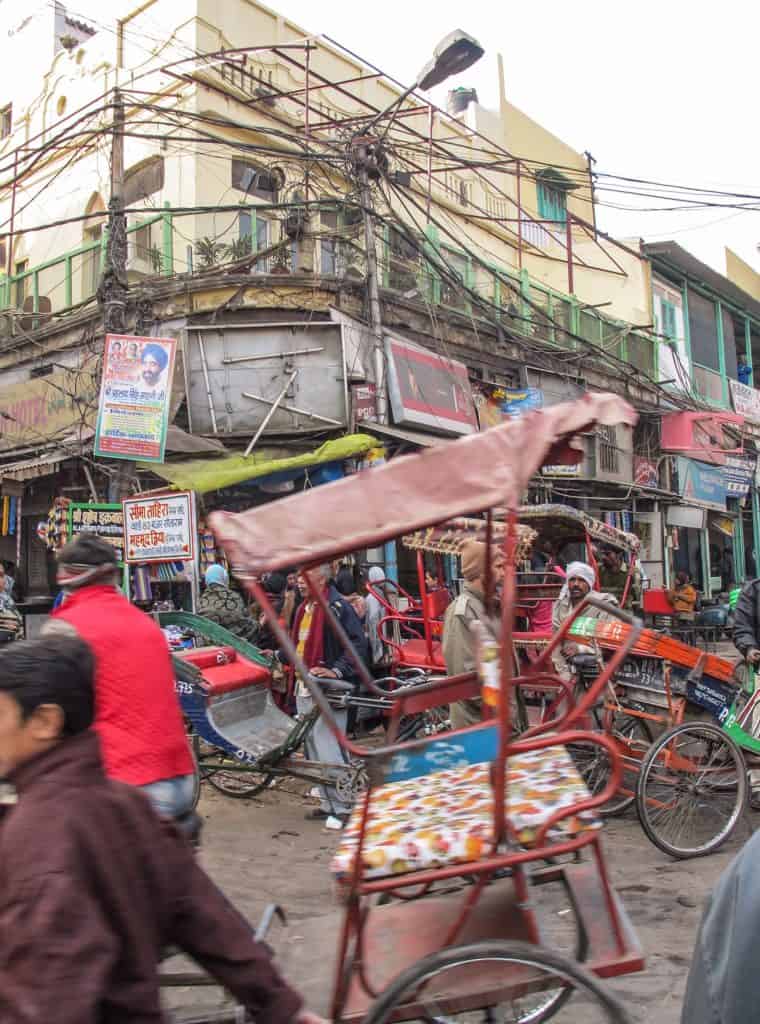 The hectic streets of Old Delhi where there are tons of bikes, rickshaws, pedestrians and power lines overlapping in every direction