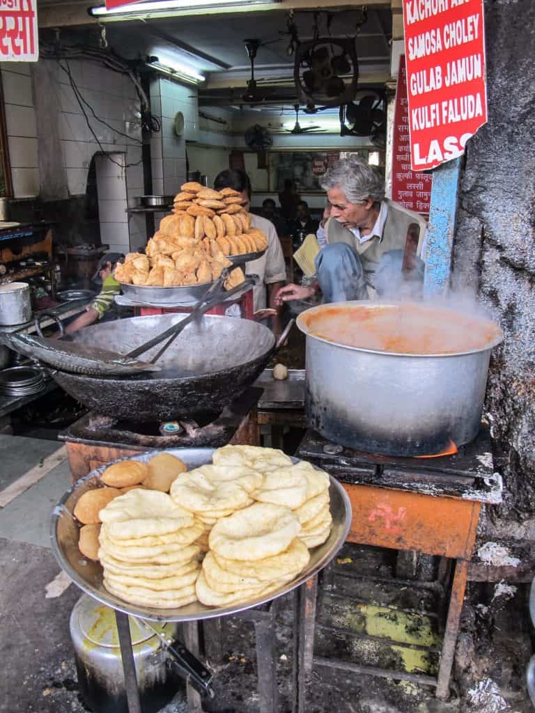 A delicious street food vendor in Old Delhi serving up hot food to order. Trying street food is a must on any Delhi itinerary.