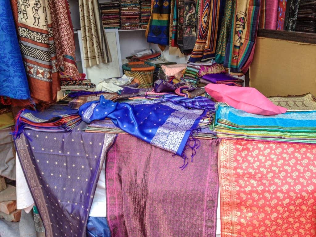 So many gorgeous and colorful scarves, saris and fabrics that make for the perfect souvenir from Dilli Haat market in Delhi