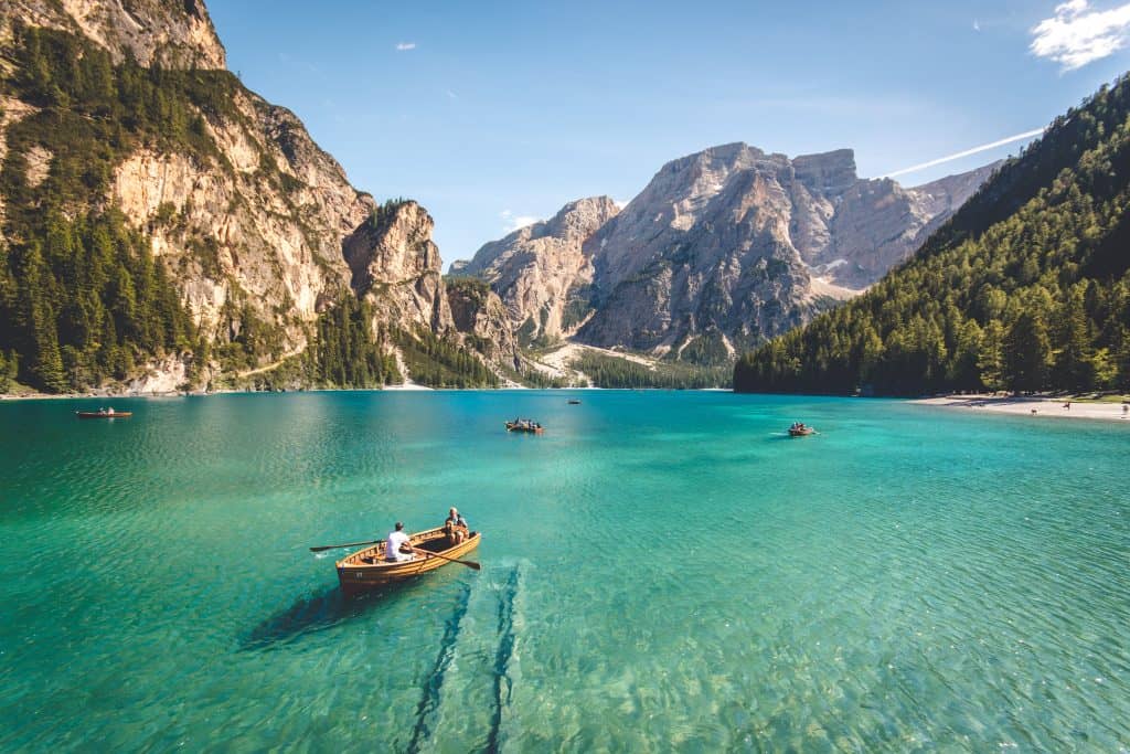 A huge beautiful lake with turquoise clear water with several kayakers on it