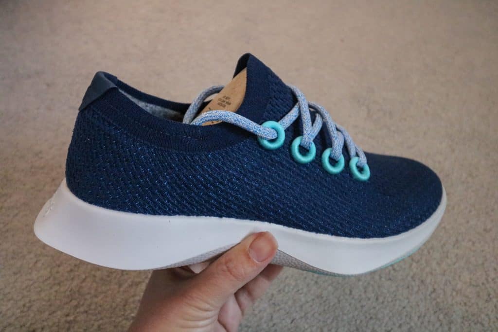 A side view of the Allbirds Tree Dashers that are made for running and have a thick supportive heel and sole cushioning.