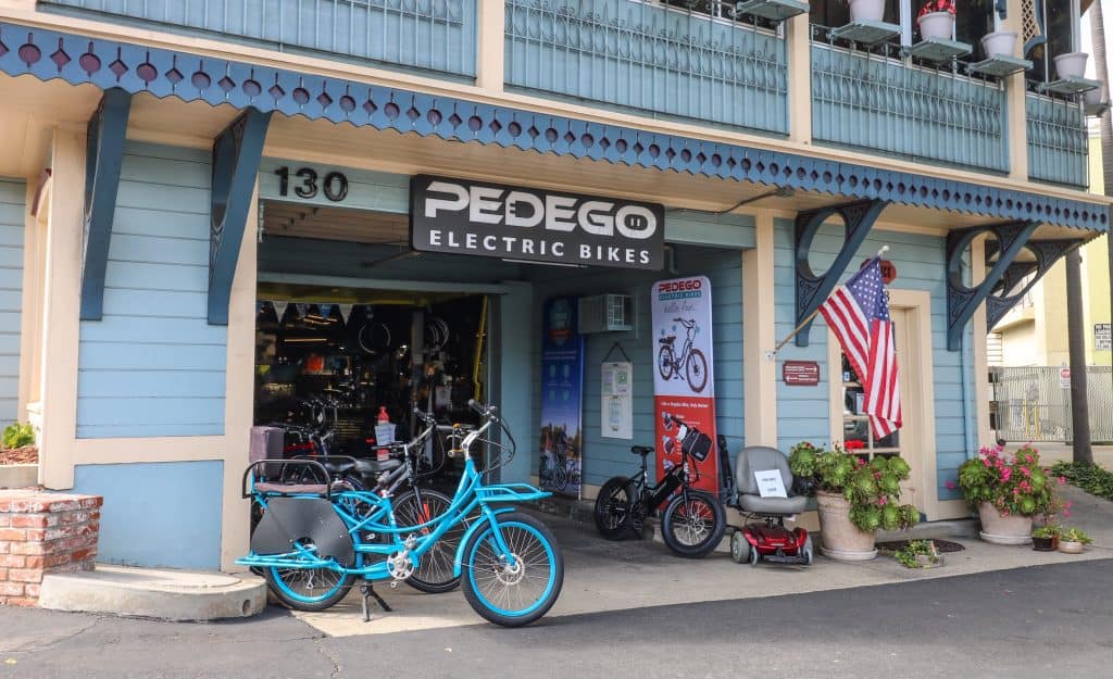 The Pedegro bike shop with a bright turquoise electric bike out front