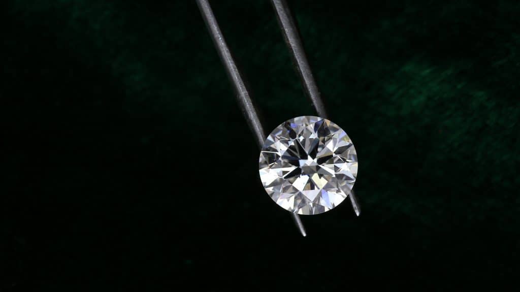 A single diamond being looked at closely