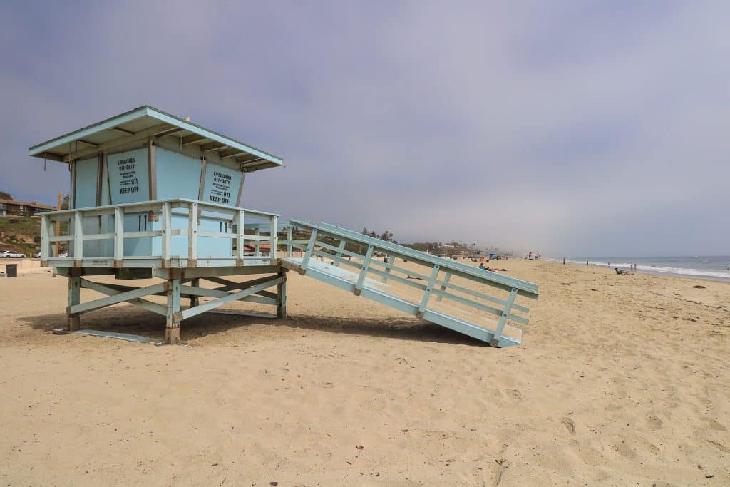 A light blue lifeguard tower on the sandy and wide Zuma Beach is one of the biggest beaches in Malibu