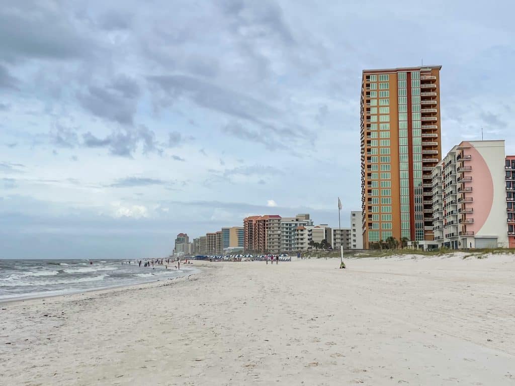 Taking an early morning walk on Orange Beach with hotels further down the beach.