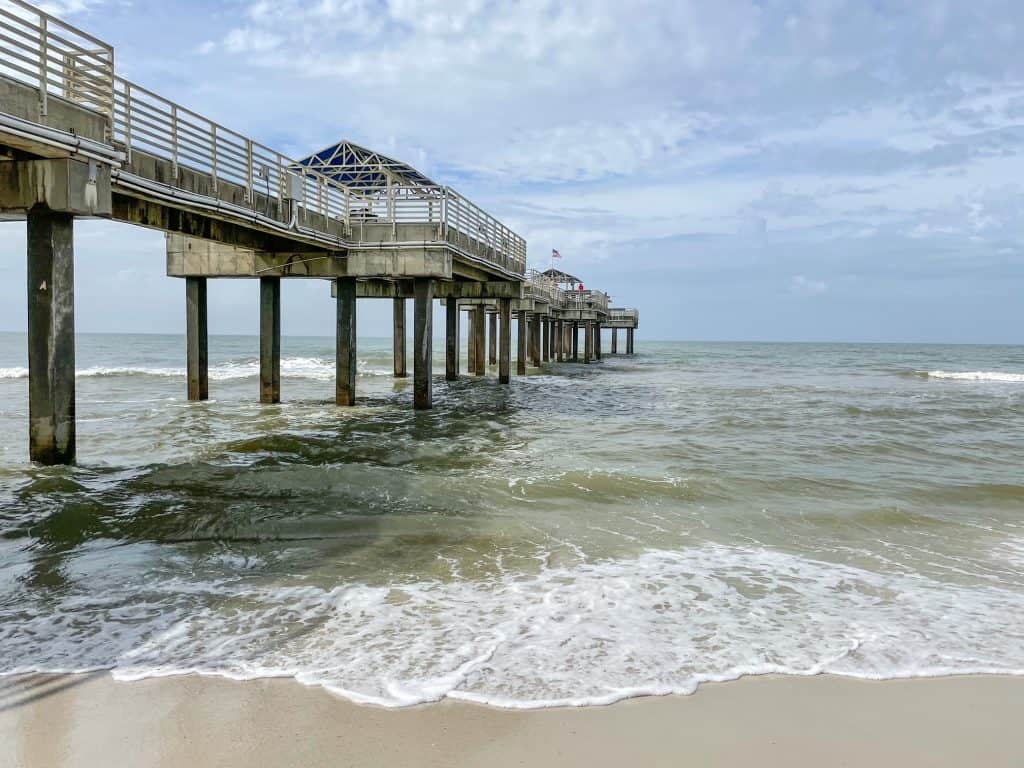 Standing where the shoreline meets the sand looking out at the Orange Beach Pier.