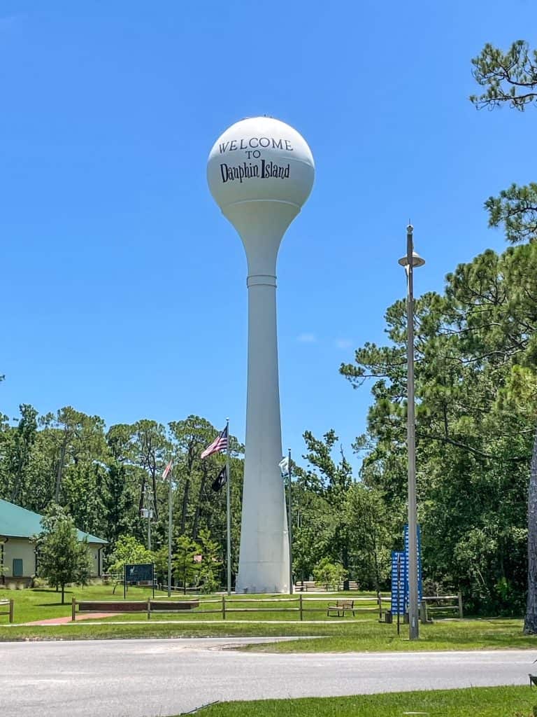 The very tall white water tower with the words Dauphin Island painted on it in blue.