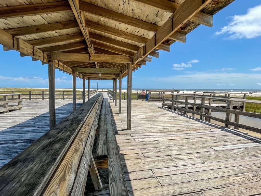 Towards the end of the pier is a shaded overhang with benches to sit and enjoy the views of Dauphin Island Beach.