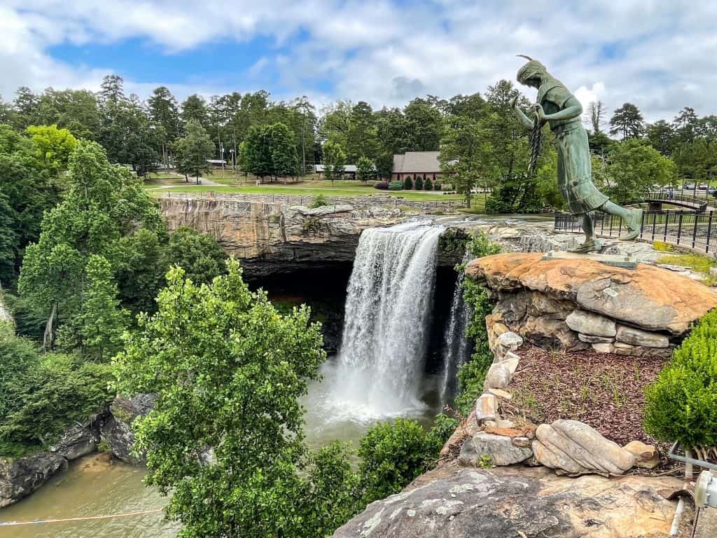 From the top platform looking out at Noccalula Falls, the statue and surrounding trees and park.