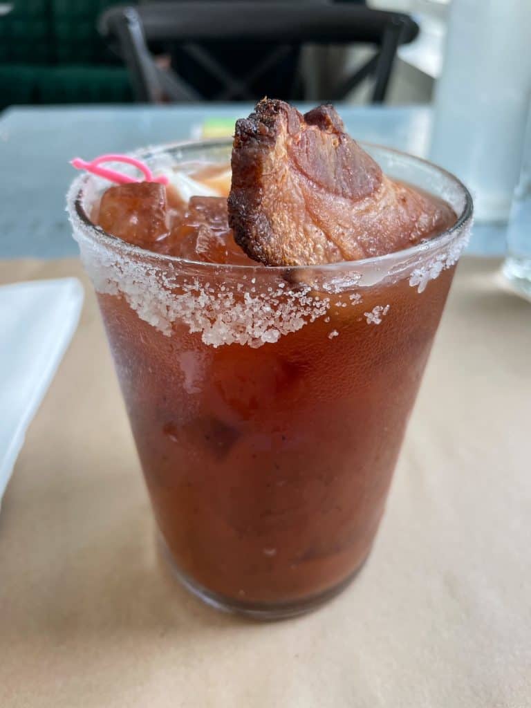Drinking a Bloody Mary with bacon and salt on the rim at Kitchen No. 324 in OKC.