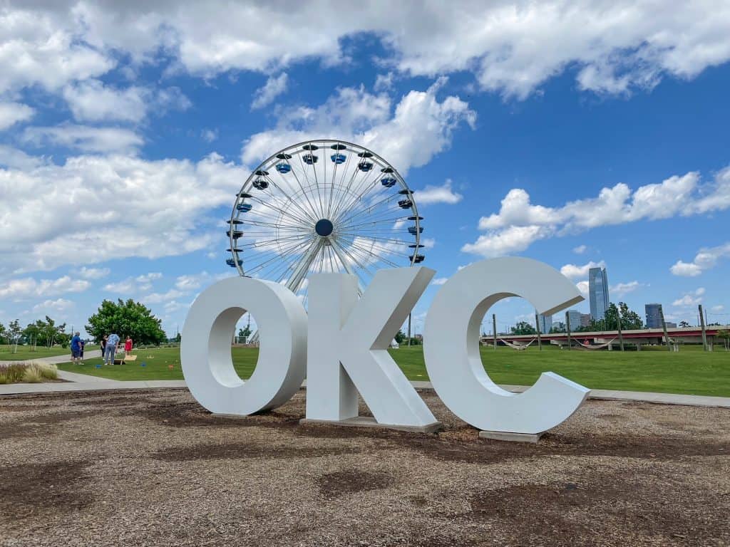 The Wheeler Ferris Wheel with the huge white letters OKC in front of it.