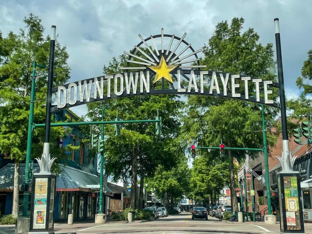 A sign that say downtown Lafayette hanging over the road as you enter downtown.