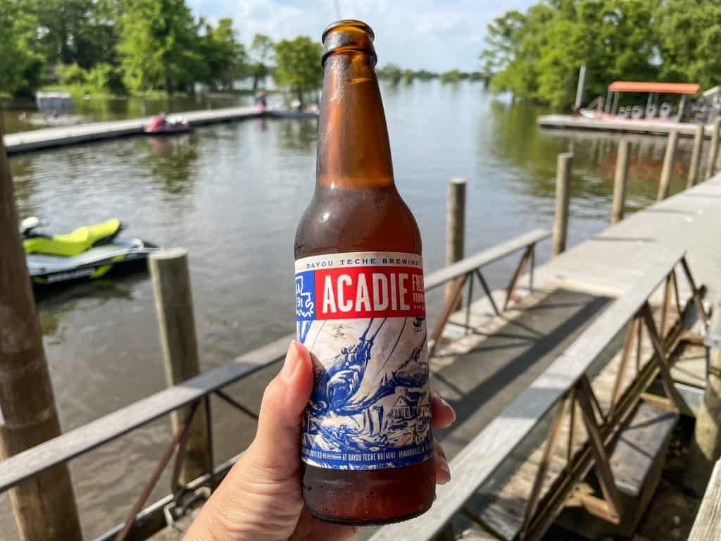 Drinking a bottle of Bayou Teche beer out on the bayou on a summer day.